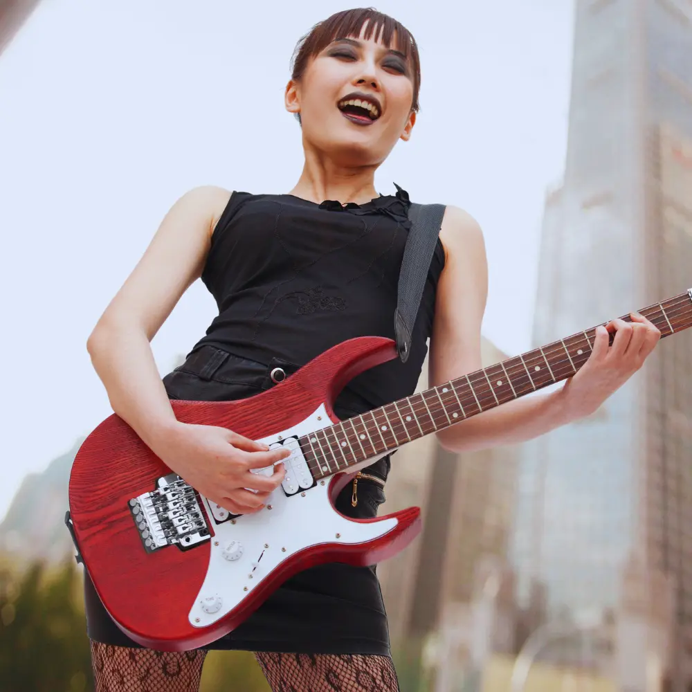 Digital music launch strategies thrive on visuals, as seen in this guitarist passionately performing outdoors with a red electric guitar.