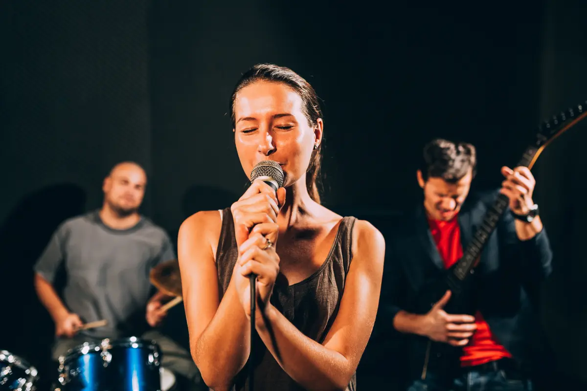 A band passionately performing in a studio, representing artists seeking music distribution deals for wider exposure.