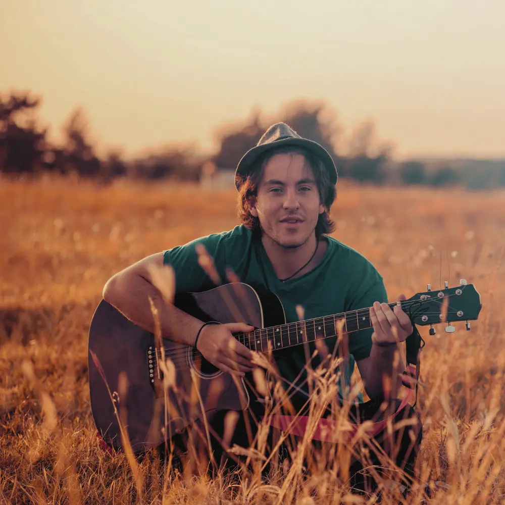 Music publishing strategies include creating original content, like this guitarist performing in a golden field at sunset.