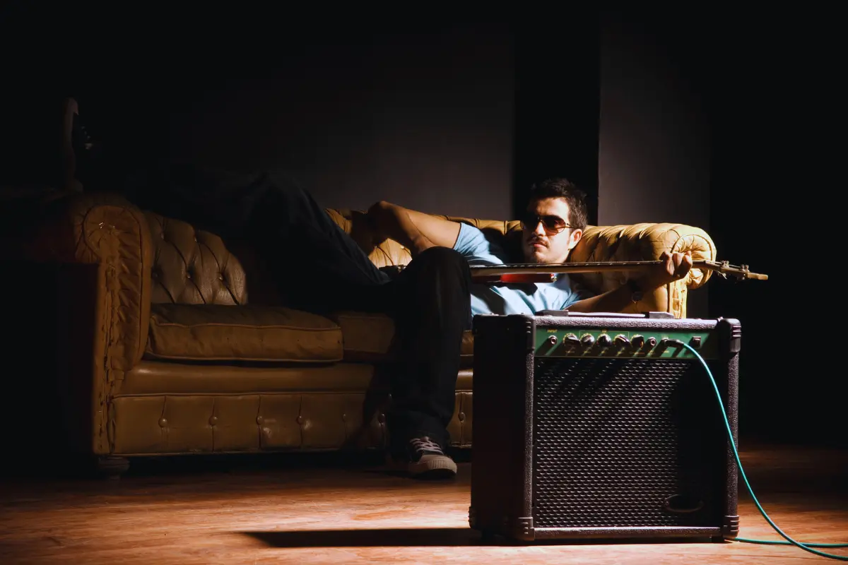 Successful music release strategies include building an image, represented by this musician lounging with a guitar and amplifier