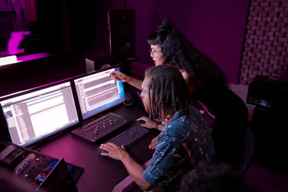 Music revenue streams explored by producers working on multi-track sessions in a modern editing suite