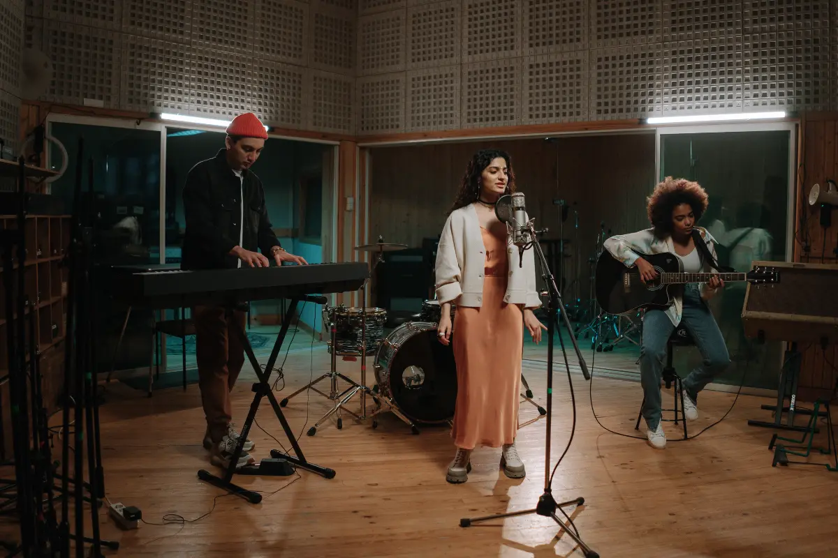 Online music collaboration platform captured in a recording session with a trio performing in a studio